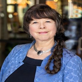 Headshot of Katharina Dress, a certified elder care mediator, founder of Aging in Harmony